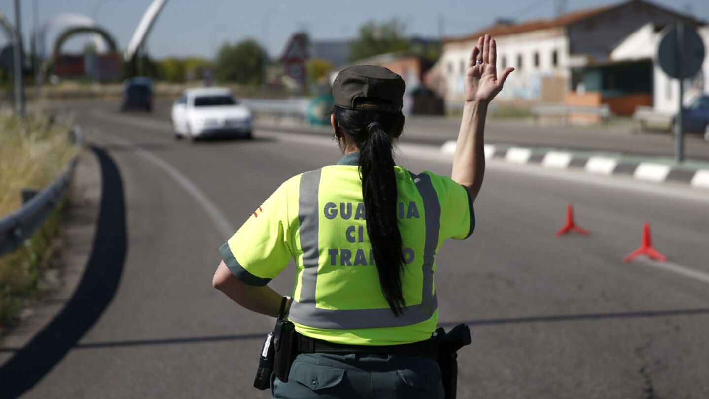 Una agente de la Guardia Civil de Tr&aacute;fico para un veh&iacute;culo