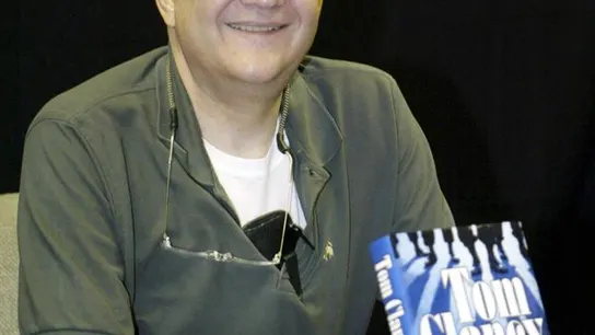 Tom Clancy posando con su libro 'Los dientes del tigre' Tom Clancy posando con su libro 'Los dientes del tigre'