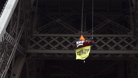 Una activista colgada del segundo piso de la Torre Eiffel en París durante una protesta Una activista colgada del segundo piso de la Torre Eiffel en París durante una protesta