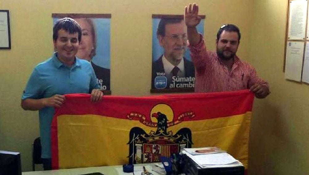 Los dirigentes de Nuevas Generaciones de Llanes posan con una bandera franquista