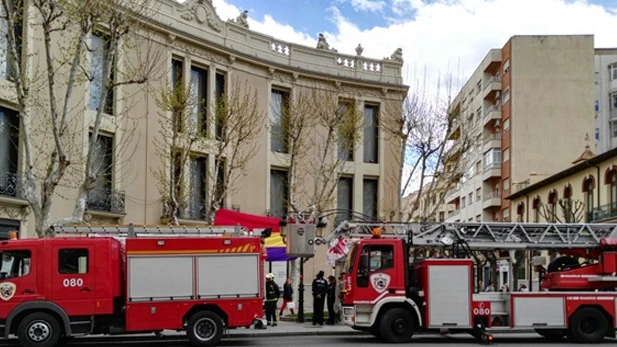 Coches de bomberos retiran una bandera de la República