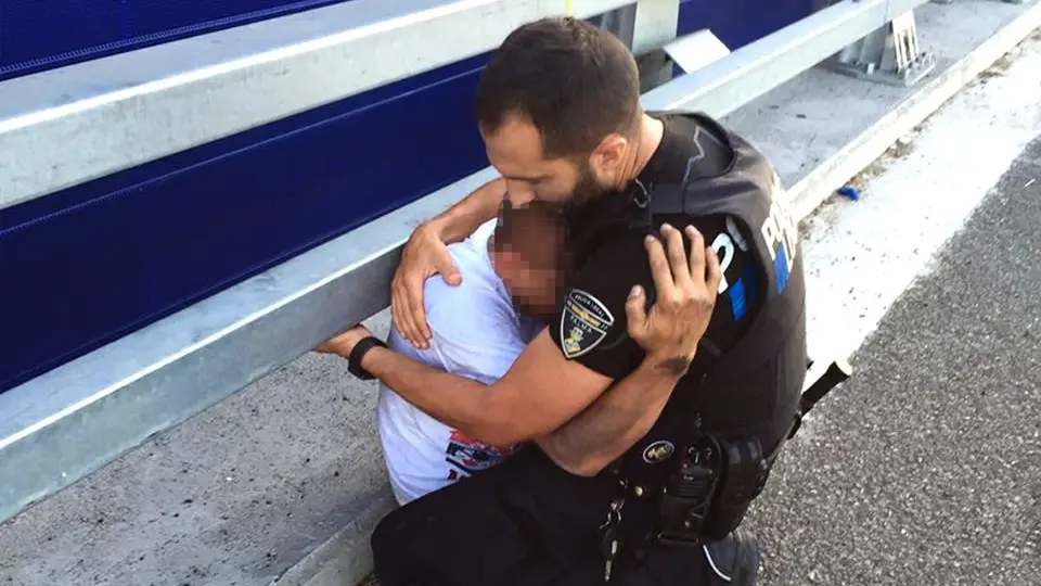 Un policía abraza a un joven que pretendía tirarse por un puente