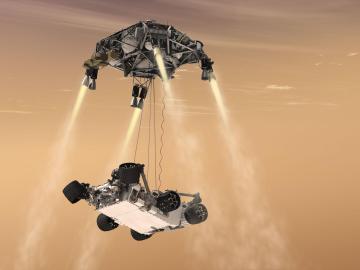 El Curiosity siendo descolgado por el skycrane suspendido en el cielo gracias a los retrocohetes