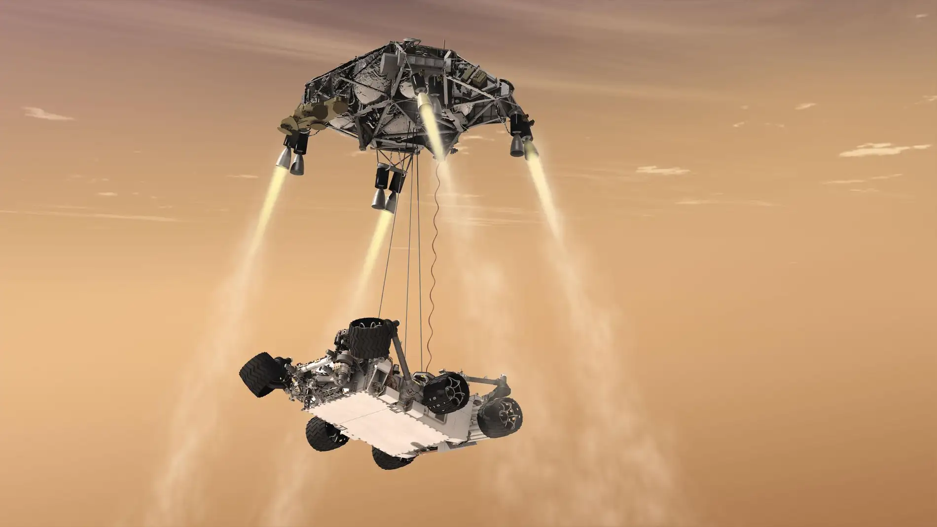 El Curiosity siendo descolgado por el skycrane suspendido en el cielo gracias a los retrocohetes