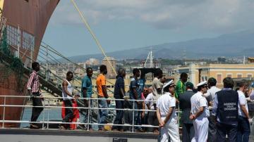 Un grupo de inmigrantes desembarca en el puerto de Catania, Sicilia 