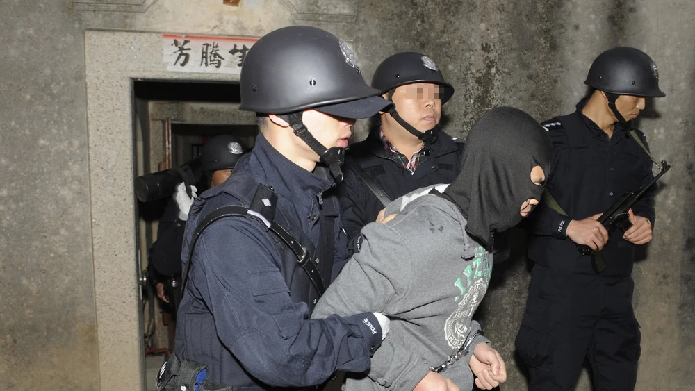 La Policía china deteniendo a varios de los sospechosos La Policía china deteniendo a varios de los sospechosos