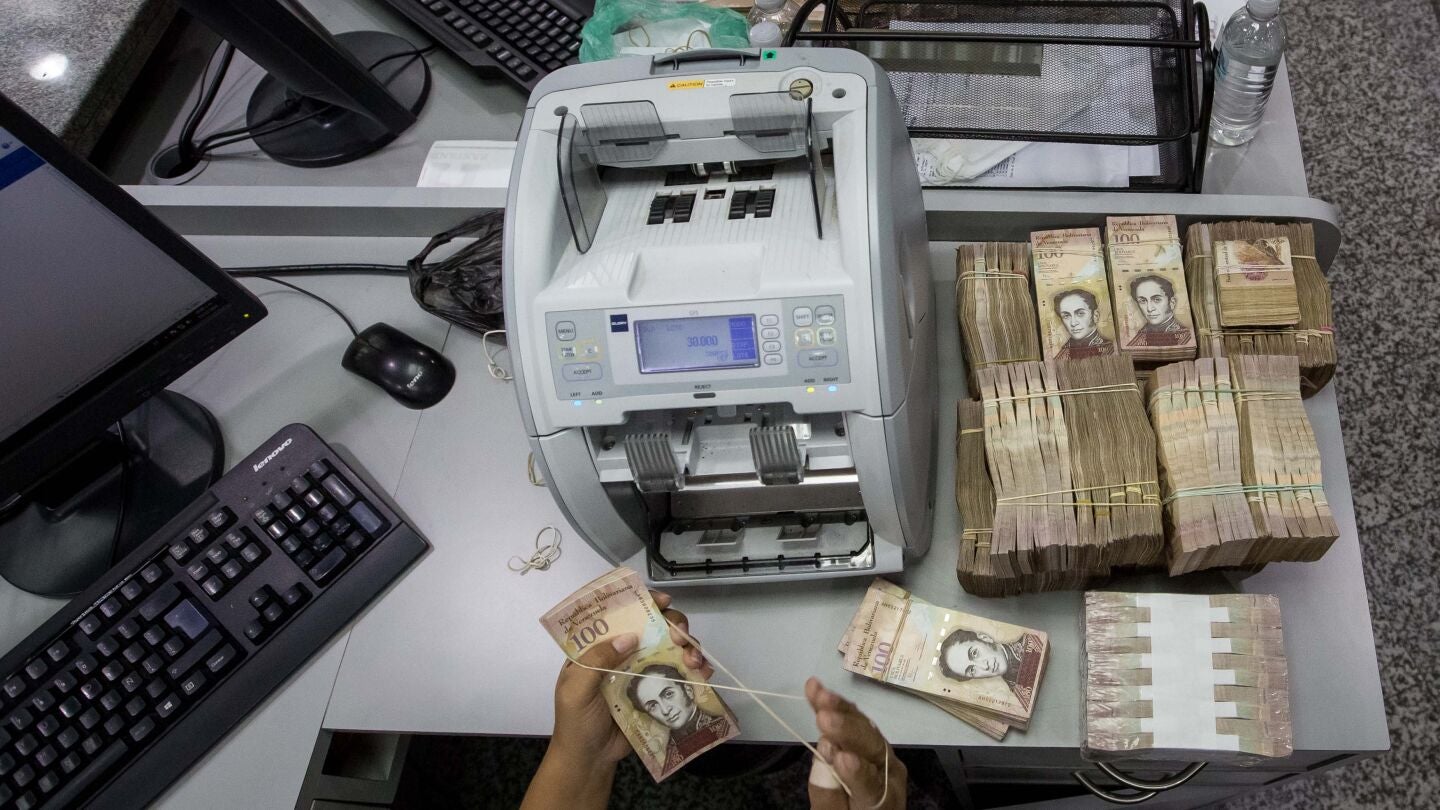 Trabajadoras de un banco cuentan billetes de 100 Bol&iacute;vares en Caracas (Venezuela)