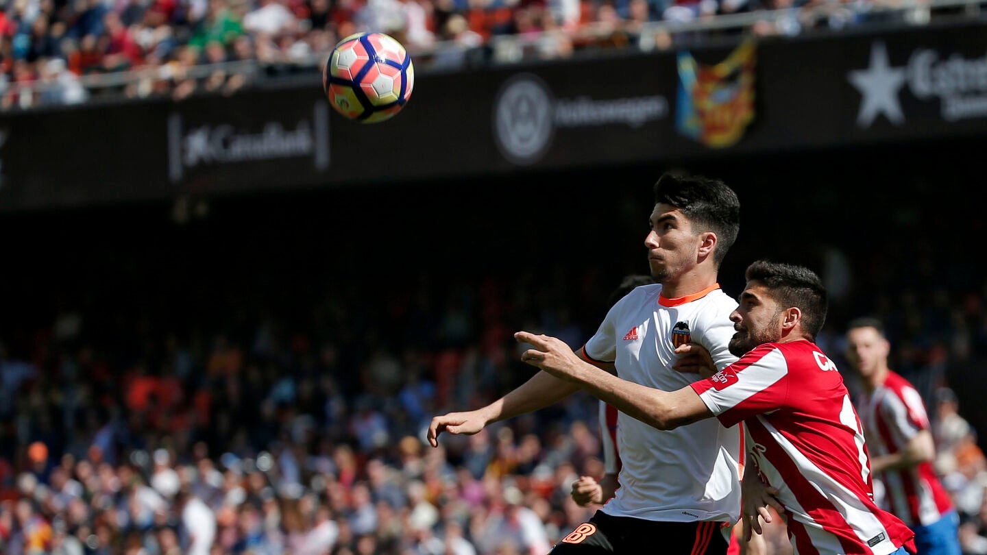 Soler y Carmona luchan por alto la posesi&oacute;n del esf&eacute;rico durante el Valencia - Sporting