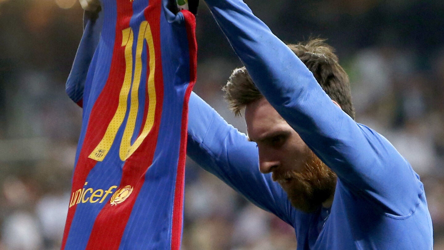 Leo Messi muestra su camiseta a la afici&oacute;n del Real Madrid