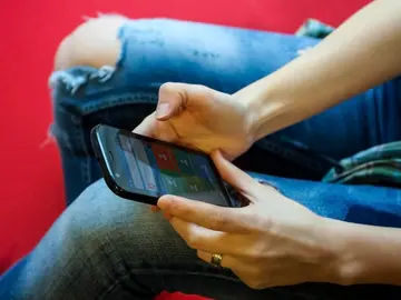 Un usuario con su teléfono móvil Android Un usuario con su teléfono móvil Android