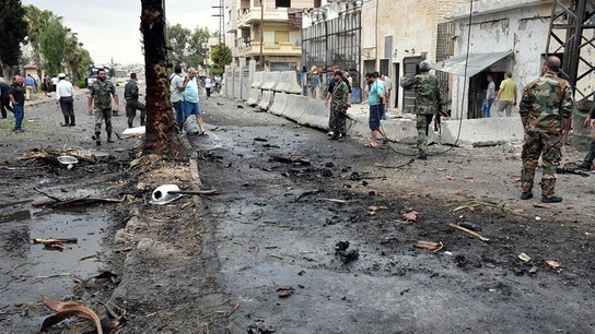 Varios policías y ciudadanos congregados en el lugar de una explosión Varios policías y ciudadanos congregados en el lugar de una explosión