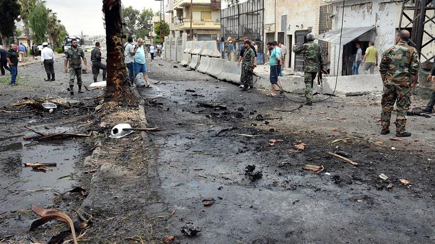 Varios policías y ciudadanos congregados en el lugar de una explosión