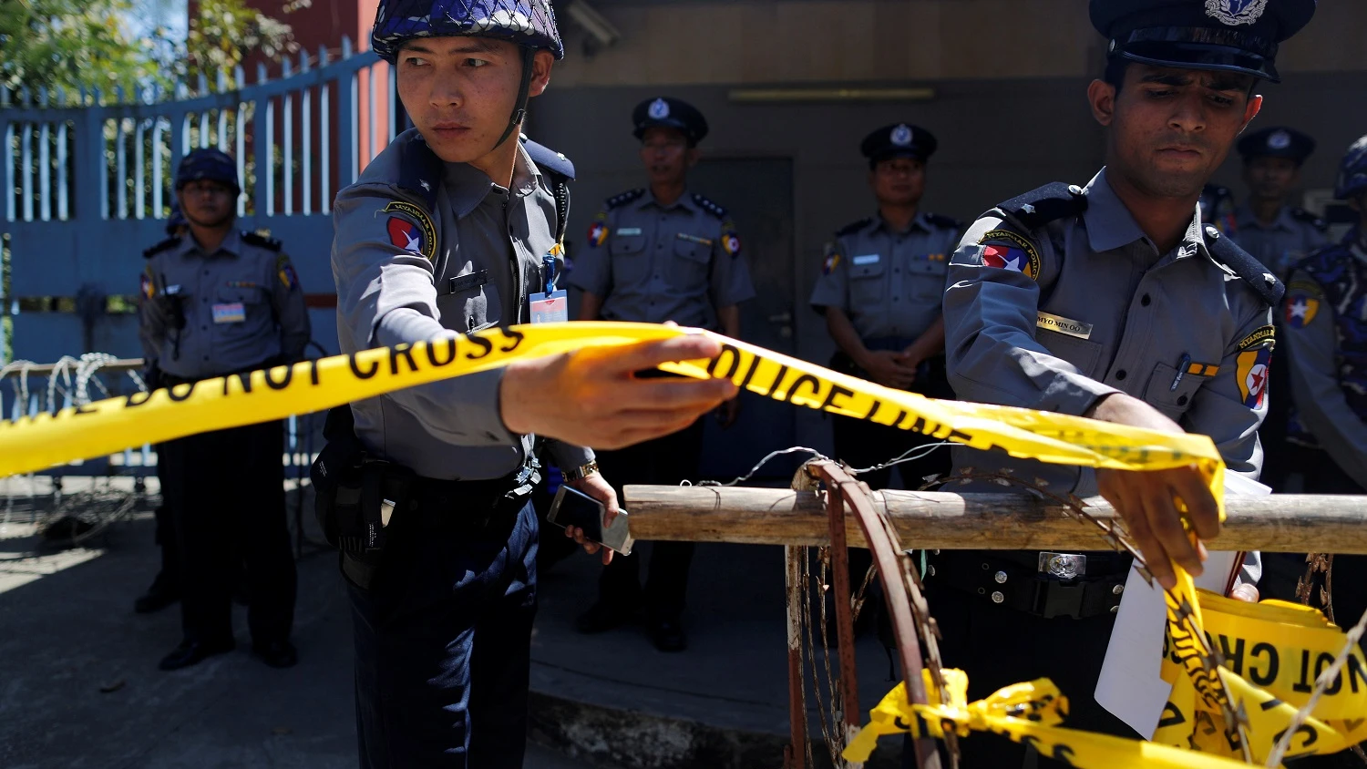 Las policías guardan la guardia durante una protesta de los monjes y de los activistas budistas de Myanmar delante de la embajada tailandesa en Yangon