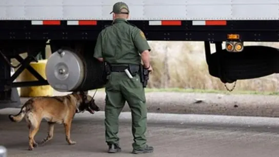 Un agente de la unidad canina de Texas vigila un camión en una foto de archivo Un agente de la unidad canina de Texas vigila un camión en una foto de archivo