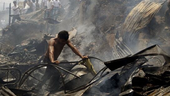 Un hombre busca sus pertenencias tras el incendio de Medell&iacute;n