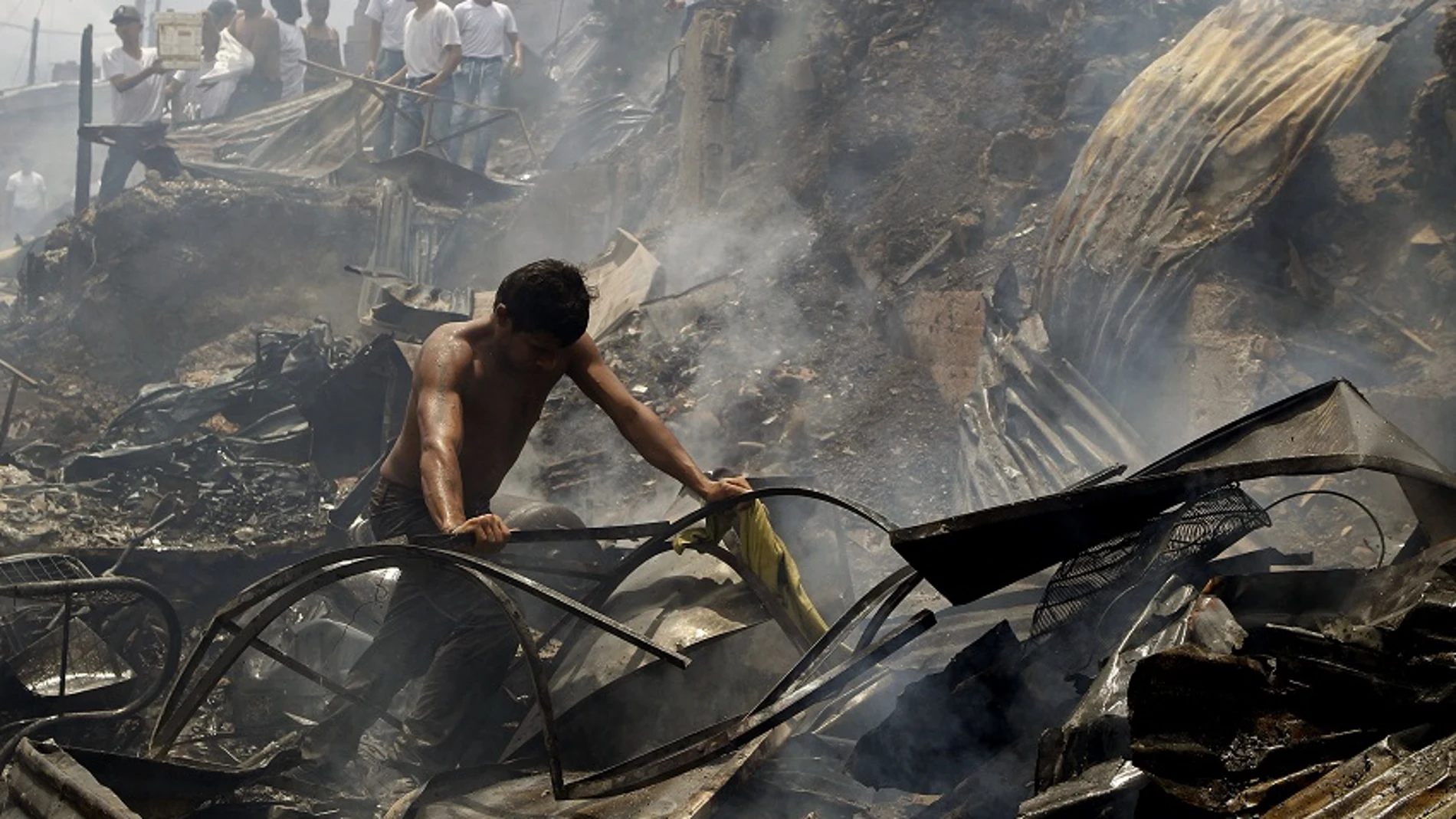 Un hombre busca sus pertenencias tras el incendio de Medellín