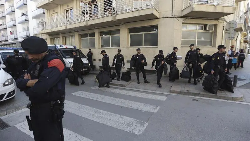 Un grupo de policías nacionales espera su transporte delante del hotel Mont-Palau de Pineda