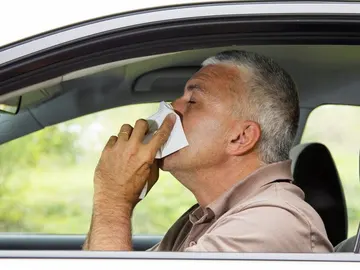 Un hombre se suena en el coche Un hombre se suena en el coche