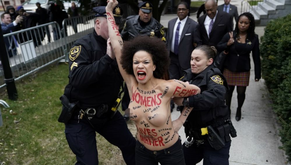Una mujer protesta en topless ante Bill Cosby