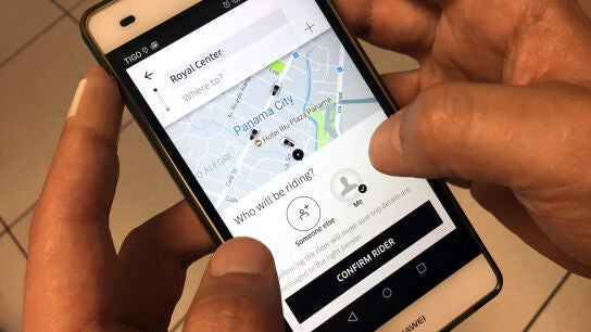 Un usuario de Uber utiliza un tel&eacute;fono m&oacute;vil.