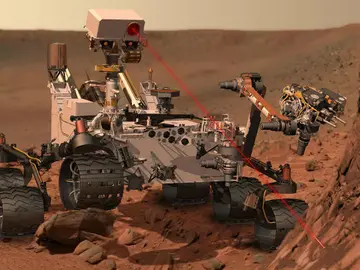 Representación artística del rover Curiosity disparando su rayo láser contra uno de los objetivos Representación artística del rover Curiosity disparando su rayo láser contra uno de los objetivos