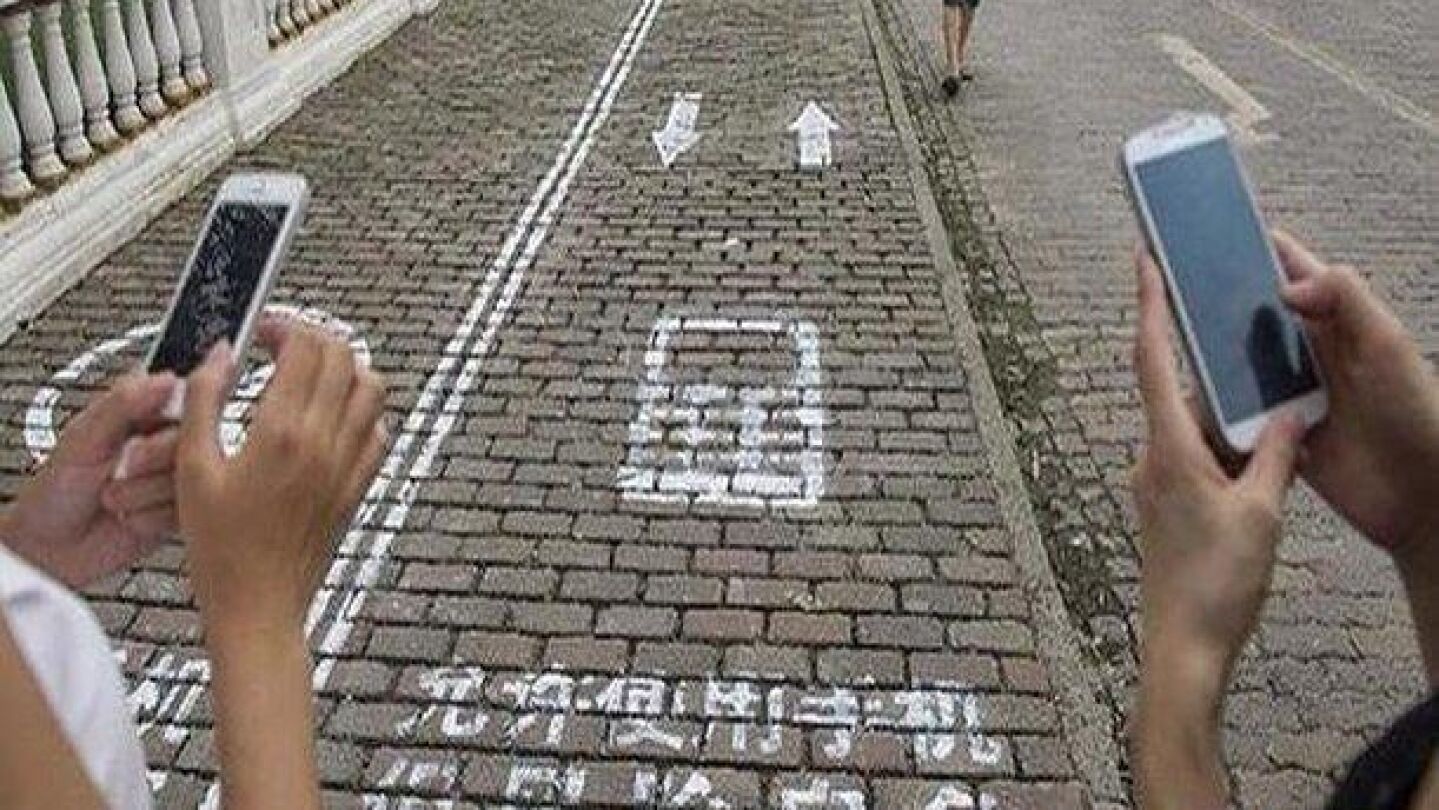 Carril para que circulen personas que utilizan su tel&eacute;fono m&oacute;vil