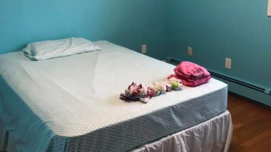 La habitación de la hija de Amanda Mitchel con la cama de la pequeña y la ropa contra el acoso La habitación de la hija de Amanda Mitchel con la cama de la pequeña y la ropa contra el acoso