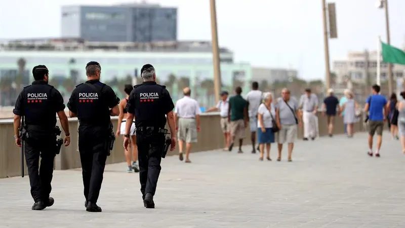 Tres Mossos d'Esquadra patrullan por el paseo marítimo de Barcelona