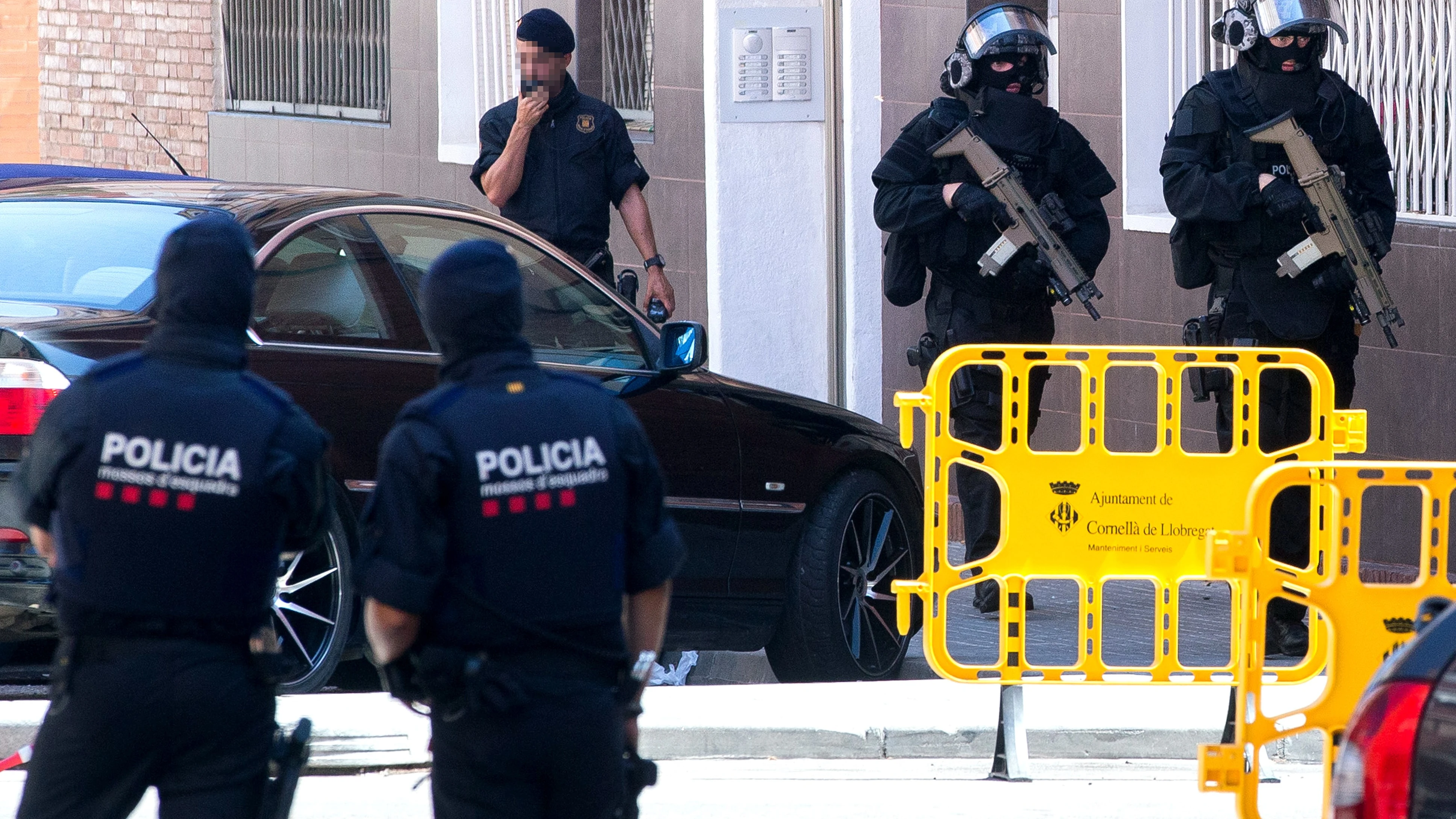 Los Mossos d'Esquadra entran para efectuar un registro en el edificio donde vivía el que hombre ha sido abatido al intentar acceder en la comisaría de los Mossos en Cornellà