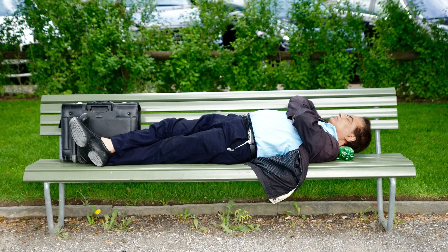 Hombre tumbado en un banco