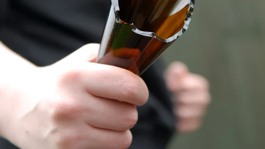 Imagen de archivo de un hombre con una botella rota Imagen de archivo de un hombre con una botella rota