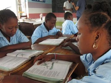 Niños leyendo un libro de texto en una escuela Niños leyendo un libro de texto en una escuela