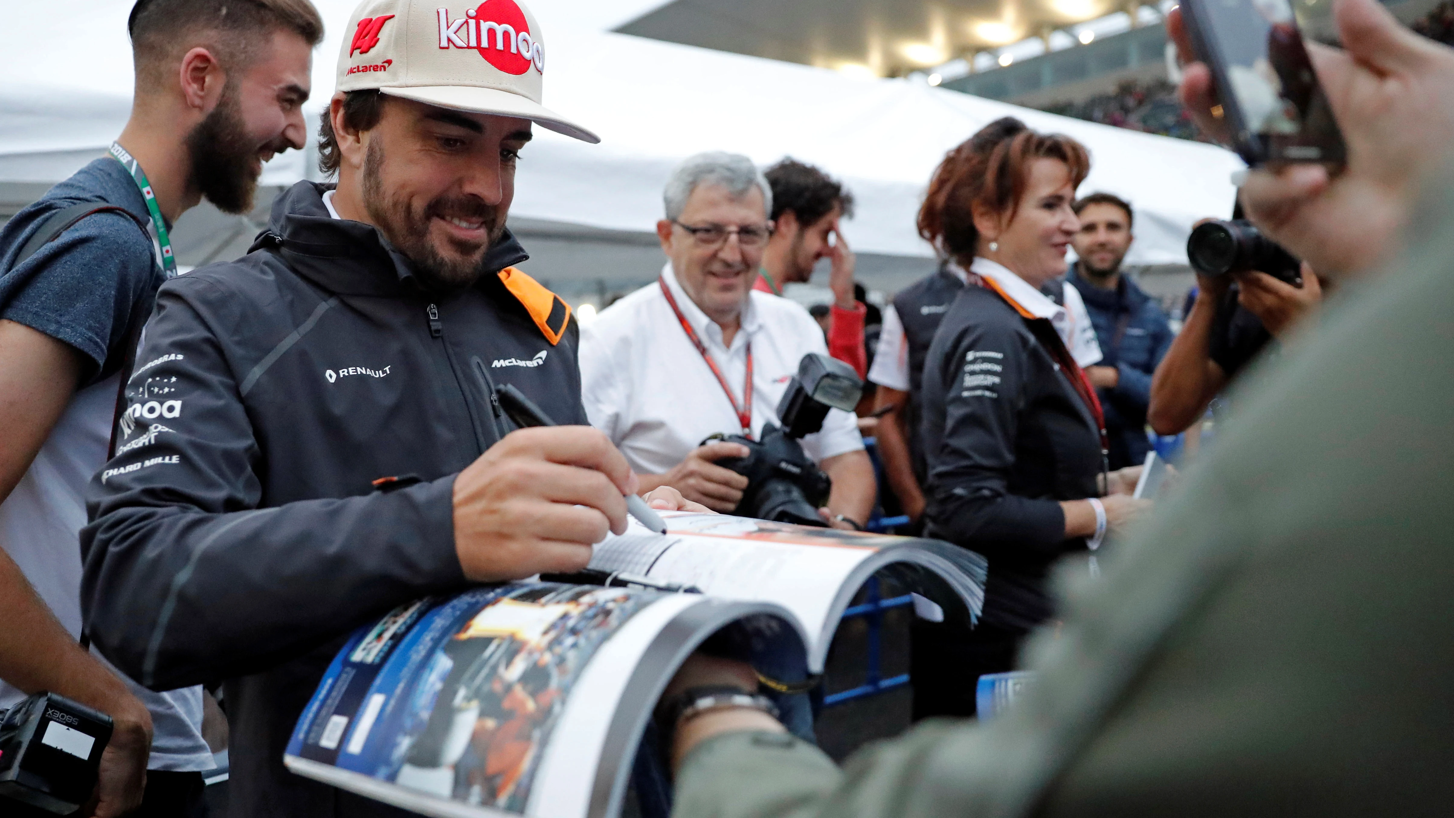 Fernando Alonso firma a un aficionado en el trazado de Suzuka