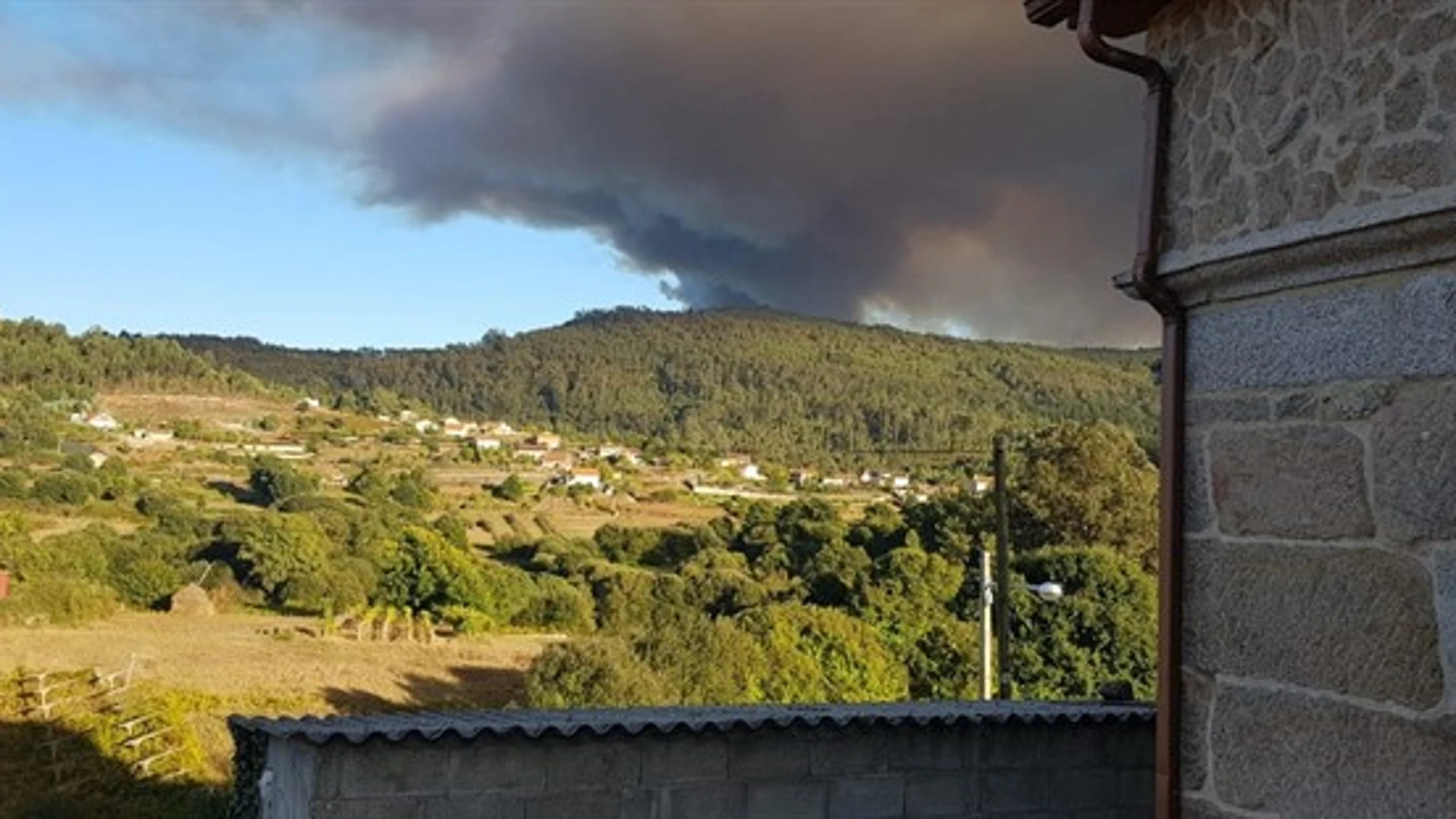 El alcalde de Mondariz asegura que la situación del incendio "está un poco más controlado" y que las casas "están fuera de peligro"