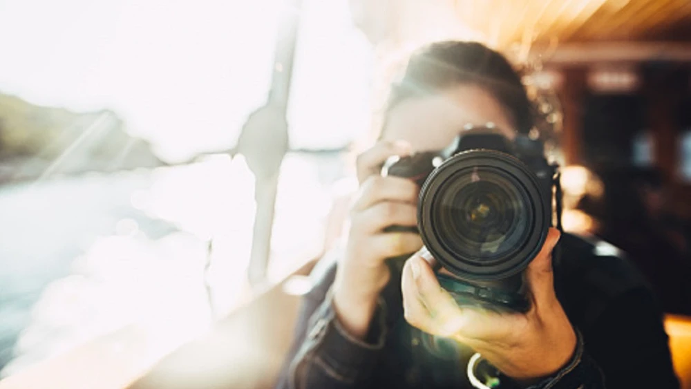 Imagen de archivo de una persona con una cámara fotográfica