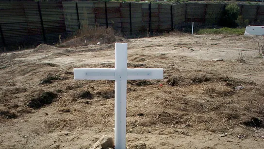 Una cruz al frente del muro que separa la frontera entre Estados Unidos y México Una cruz al frente del muro que separa la frontera entre Estados Unidos y México