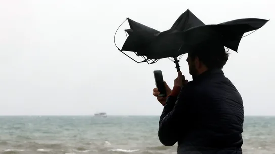 Imagen de archivo de una persona en la Playa de la Malvarrosa de Valéncia bajo la lluvia y el fuerte viento. Imagen de archivo de una persona en la Playa de la Malvarrosa de Valéncia bajo la lluvia y el fuerte viento.