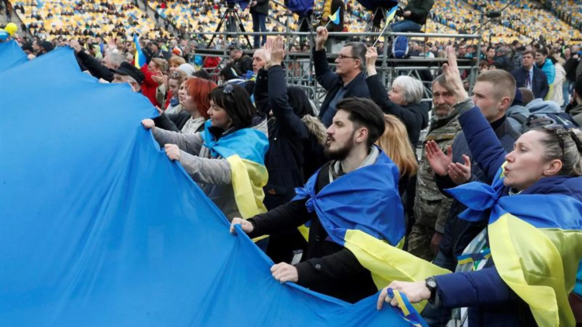 Varias personas asisten al debate que se ha celebrado en el estadio Olímpico de Kiev