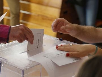 Imagen de archivo de un votante depositando su papeleta en las urnas.