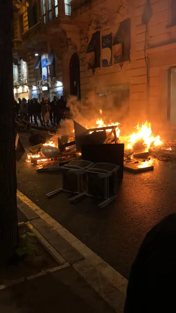 Mobiliario de las terrazas ardiendo en una barricada en la Rambla de Cataluña