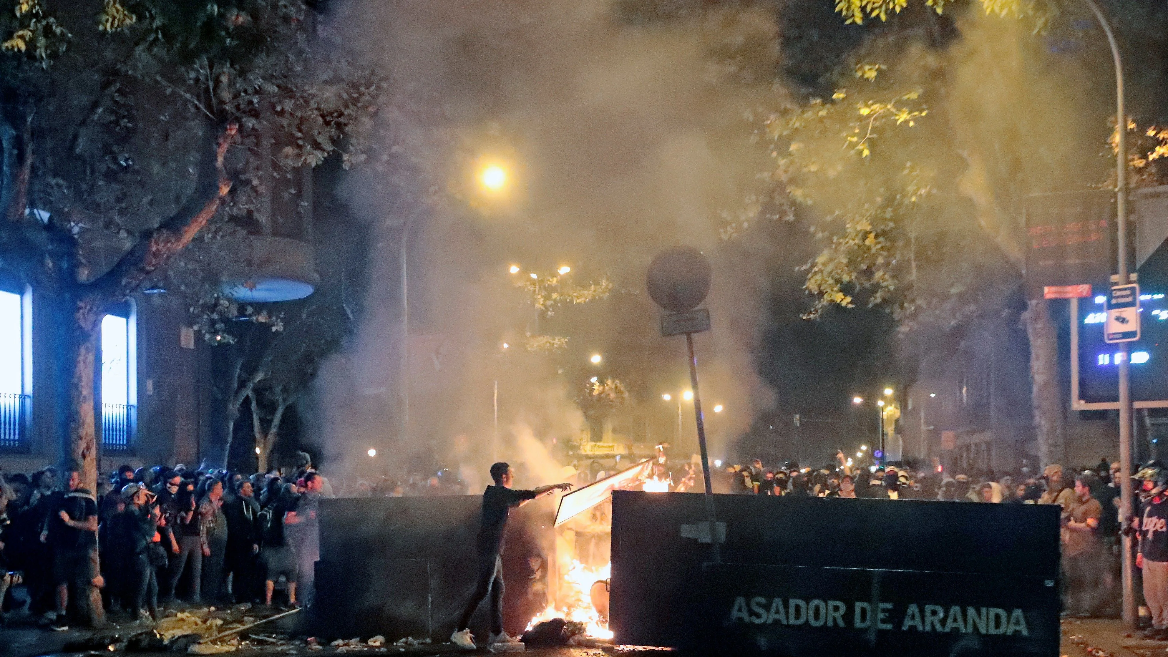 Centenares de manifestantes junto a una barricada de fuego