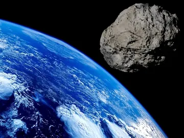 Un asteroide volando sobre la Tierra Un asteroide volando sobre la Tierra