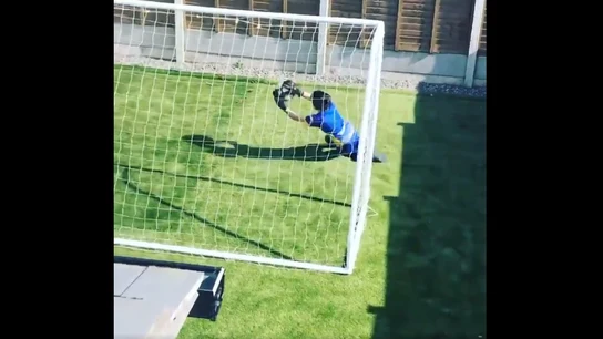 Un joven portero entrenando solo en casa Un joven portero entrenando solo en casa