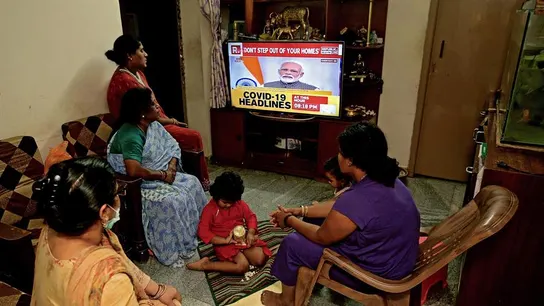 Una familia india escucha en la televisión el discurso del primer ministro sobre la alerta por COVID-19. Una familia india escucha en la televisión el discurso del primer ministro sobre la alerta por COVID-19.