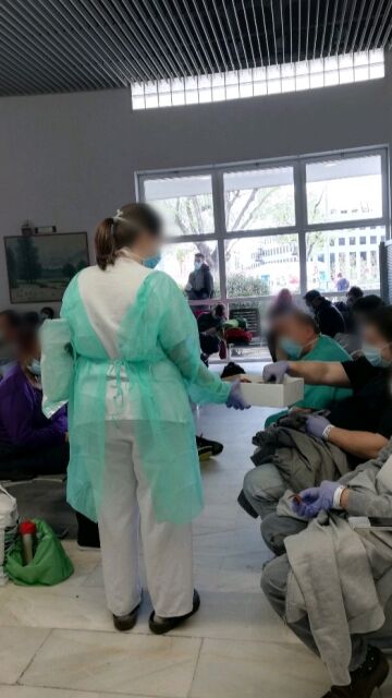 Personal sanitario reparte sándwiches entre los pacientes.