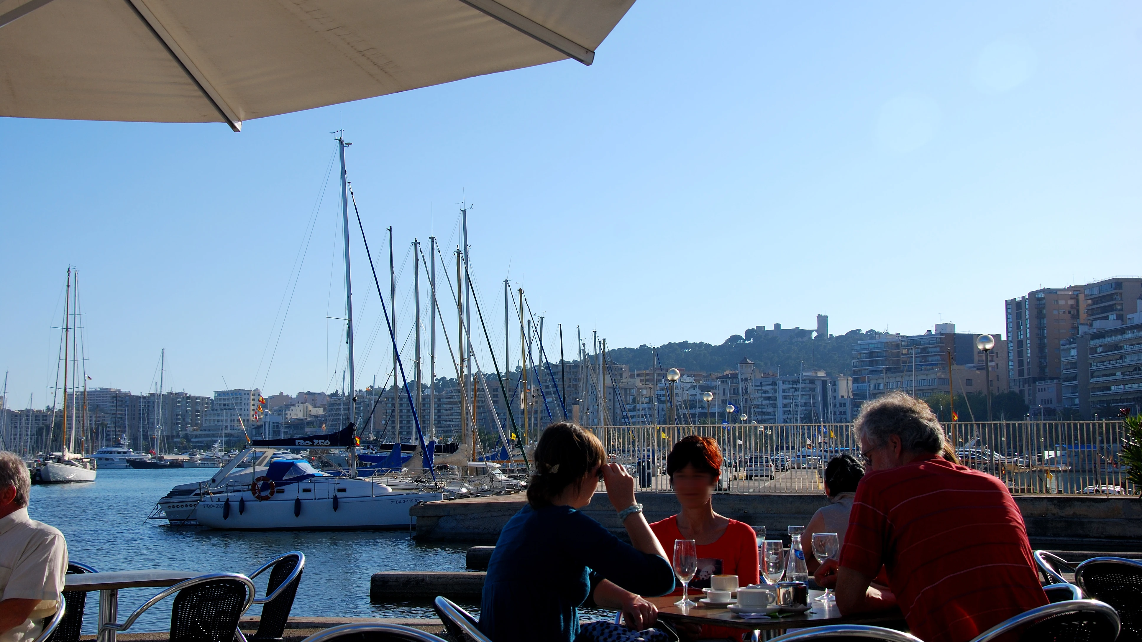 Gente disfrutando de una terraza frente al mar, en el Paseo Marítimo de Palma.