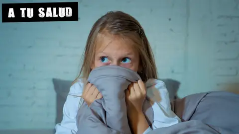 Una niña con miedo en la cama Una niña con miedo en la cama