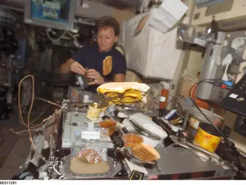 Astronauta preparando una comida. Astronauta preparando una comida.
