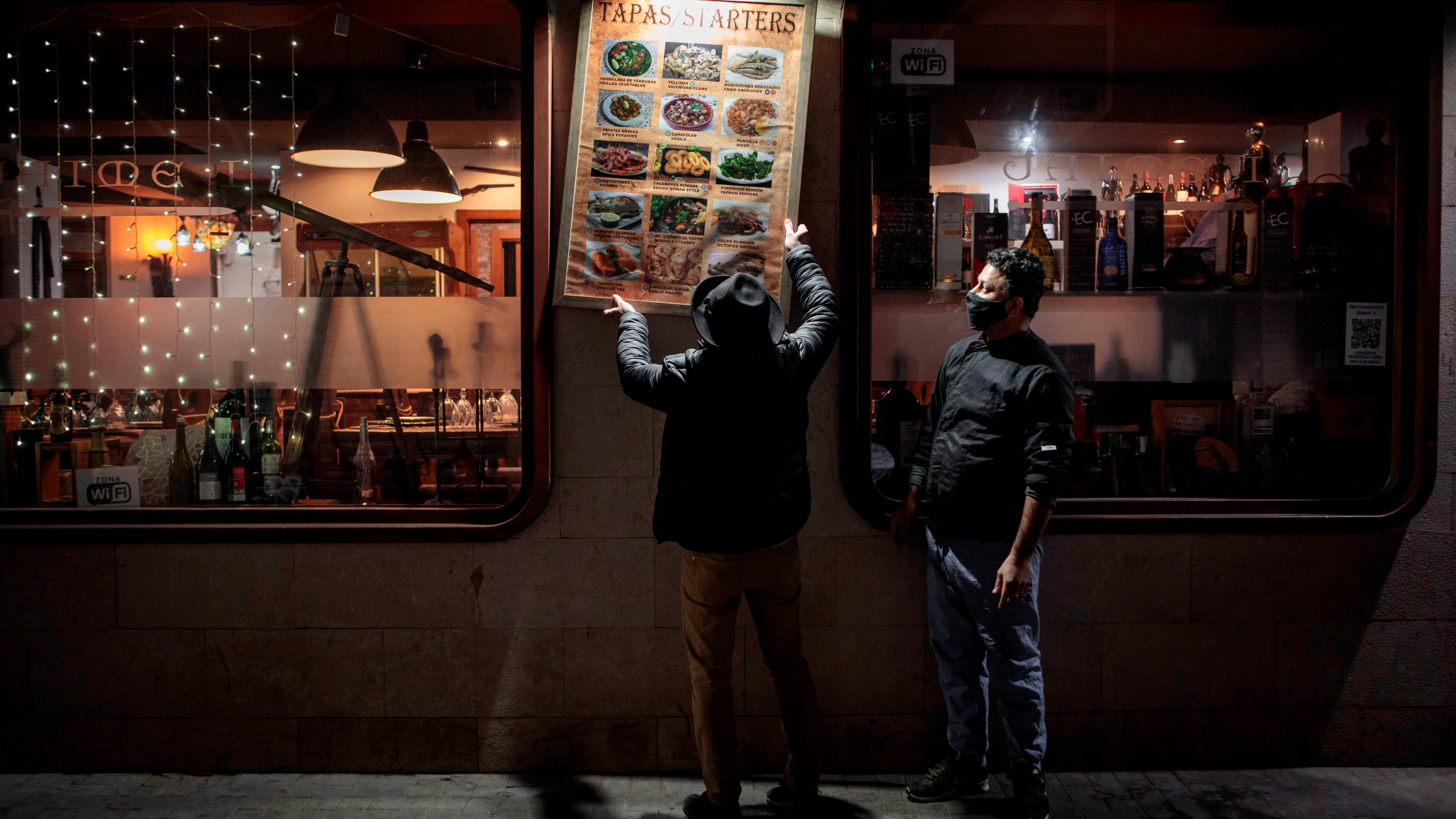 Unos trabajadores de un restaurante del centro de Valencia recogen la terraza