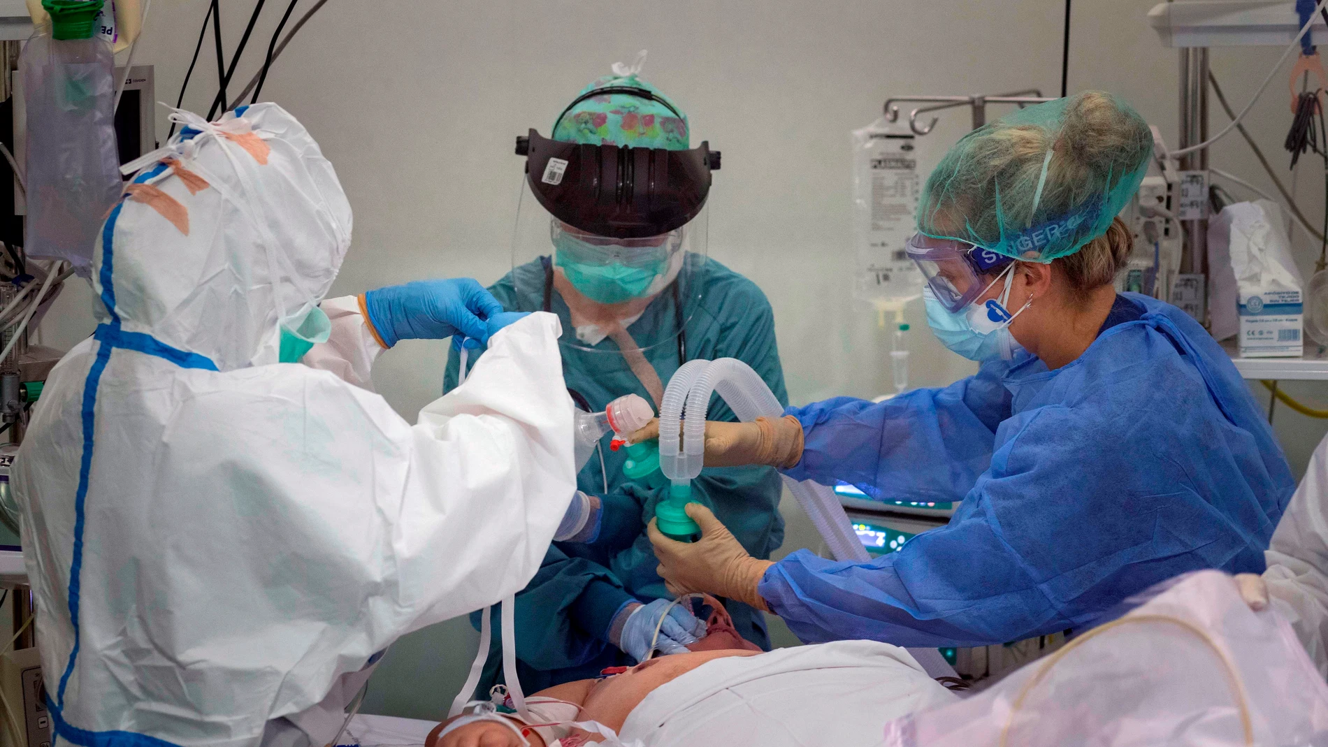 Una doctora y dos enfermeras atienden a un paciente de coronavirus